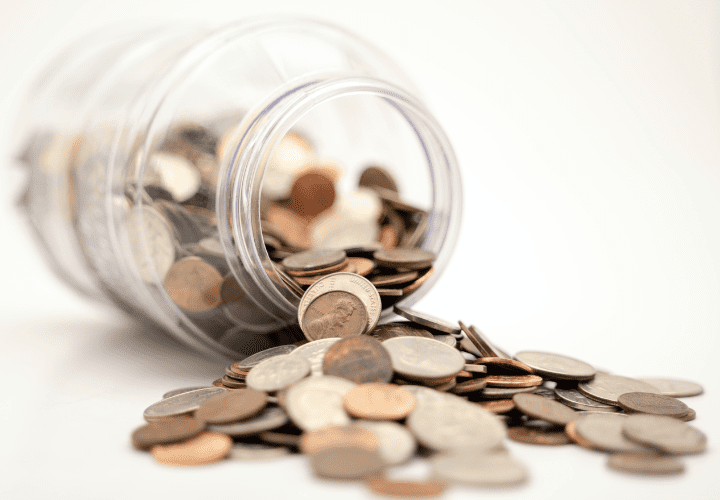 Coins spreading out of a jar