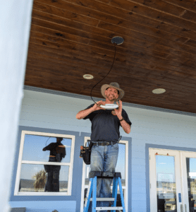 Man installs a new access point for RV park Wi-Fi equipment