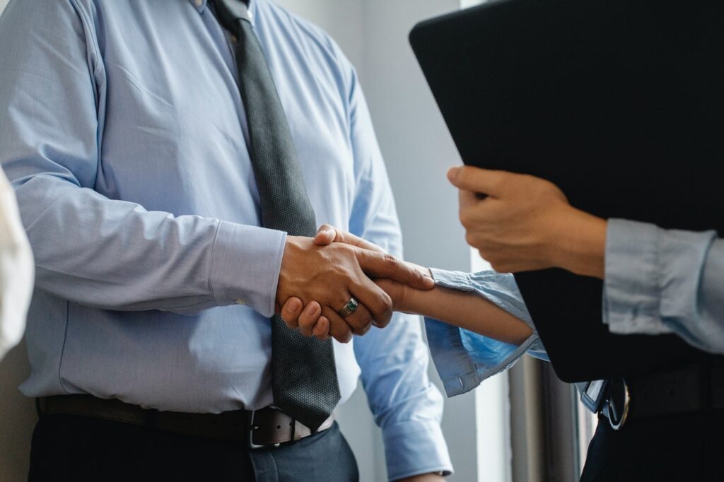 Client and service provider representative shake hands